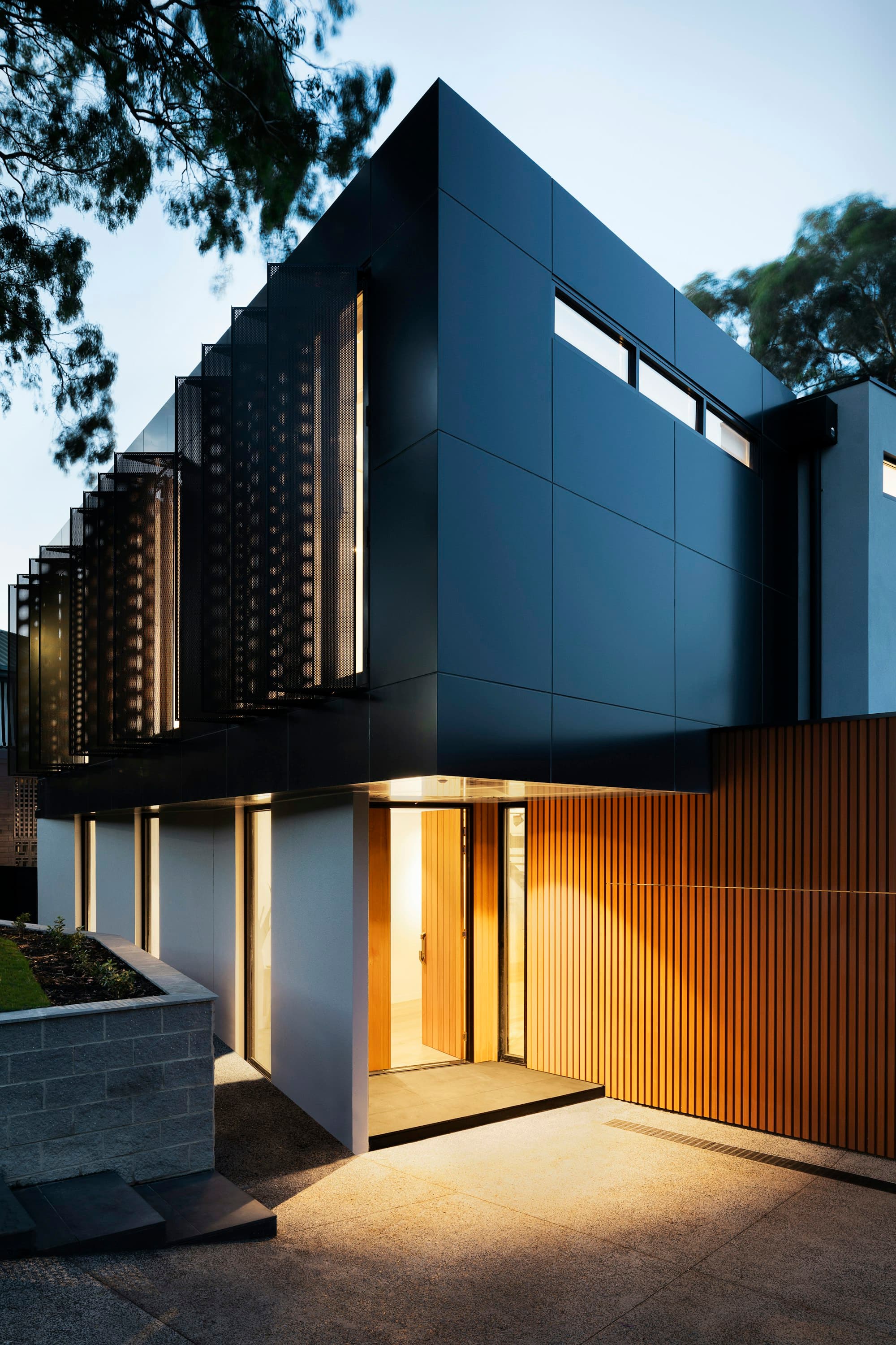 Modern home lit up at dusk